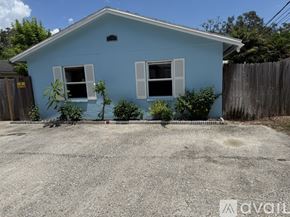 Clearwater apartment for rent - A blue house with a gravel driveway in front.