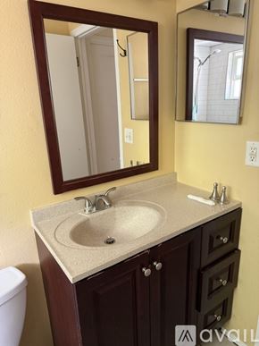 Clearwater apartment for rent - A bathroom with a sink, mirror, and toilet.