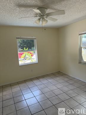Clearwater apartment for rent - A room with a ceiling fan and two windows.