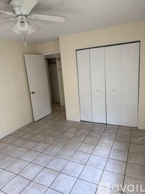 Clearwater apartment for rent - A room with a ceiling fan and a door.