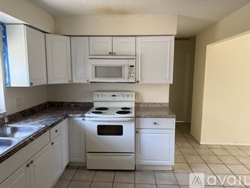 Clearwater apartment for rent - A kitchen with white cabinets and a white stove top oven.