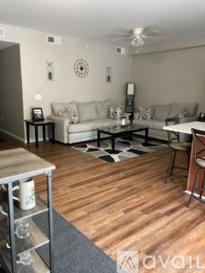 Cincinnati apartment for rent - A living room with a couch, a coffee table, and a ceiling fan.