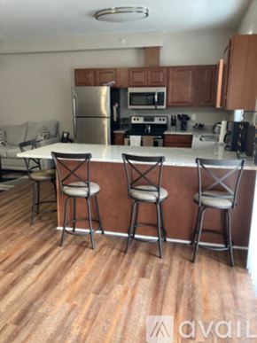 Cincinnati apartment for rent - A kitchen with a bar stool in front of the counter.