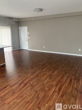 Cincinnati apartment for rent - A room with wooden flooring and a white door.