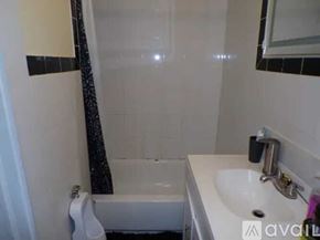 Bridgeport townhouse for rent - A white sink is on a counter next to a white bathtub.