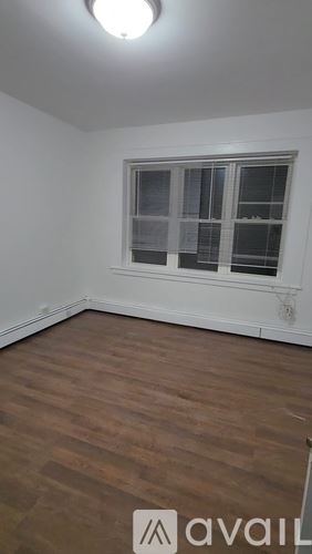 Bridgeport townhouse for rent - A room with a window and wooden flooring.
