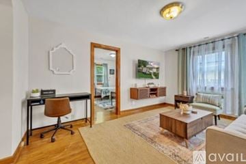 Portsmouth house for rent - A living room with a brown chair and a brown coffee table.