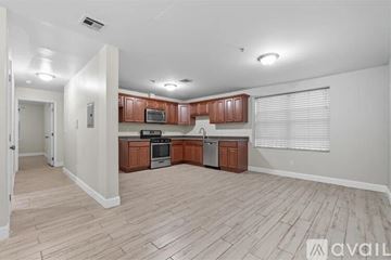 Newark apartment for rent - A kitchen with wooden cabinets and a stainless steel oven.