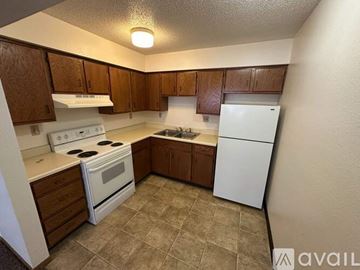Humboldt apartment for rent - A kitchen with white appliances and brown cabinets.