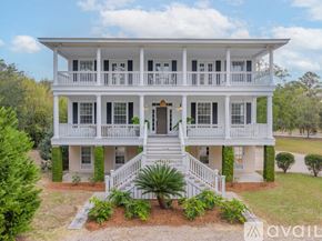Savannah house for rent - A white two-story house with a balcony on the second floor.