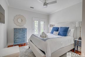 Savannah house for rent - A bedroom with a large bed and a blue dresser.