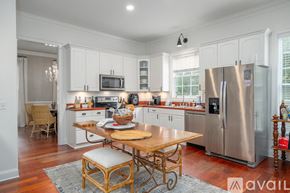 Savannah house for rent - A kitchen with a wooden table and stainless steel appliances.