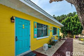 Englewood apartment for rent - A yellow house with a blue door and window.