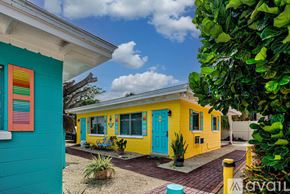 Englewood apartment for rent - A yellow house with a blue door and a red window.