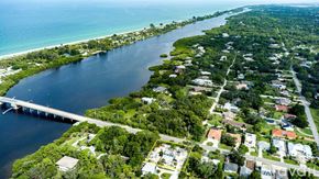 Englewood apartment for rent - A bridge spans a body of water with a residential area on the other side.