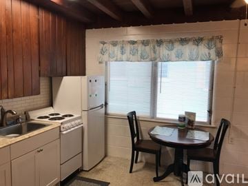 Englewood apartment for rent - A kitchen with a table and chairs in front of a window.