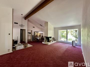 Plano house for rent - A living room with a red carpet and a fireplace.