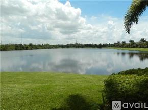 Bradenton townhouse for rent - A large body of water surrounded by green grass under a cloudy sky.