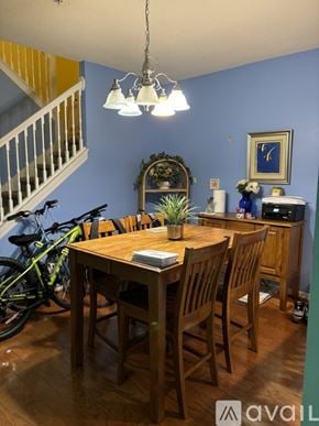 Bradenton townhouse for rent - A dining room with a wooden table and chairs.