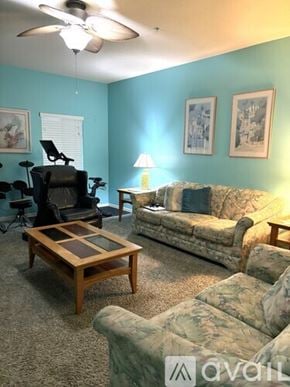 Bradenton townhouse for rent - A living room with a couch, chair, and coffee table.
