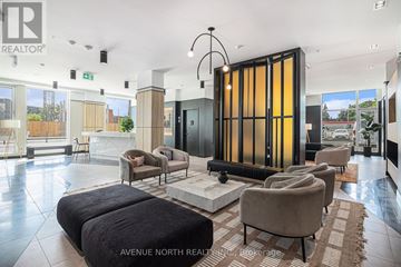 Ottawa condo for rent - A modern living room with a large sofa set and a glass door.