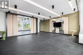Ottawa condo for rent - A spacious room with a large window and a flat-screen TV mounted on the wall.
