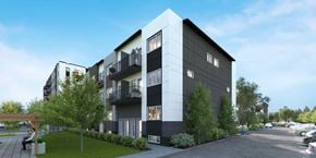Winnipeg apartment for rent - A modern apartment building with a parking lot in front.