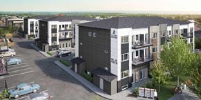 Winnipeg apartment for rent - A modern apartment complex with a parking lot in front.