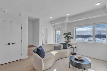 Winnipeg apartment for rent - A modern living room with a white couch and a coffee table.
