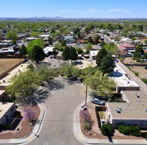 Albuquerque apartment for rent - A view of a roundabout with a few cars and trees in the foreground.