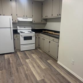 Albuquerque apartment for rent - A kitchen with a white fridge, white stove, and white oven.