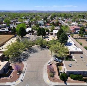 Albuquerque apartment for rent - A view of a roundabout with a few cars and trees in the foreground.