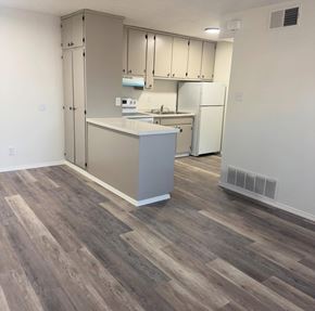 Albuquerque apartment for rent - A kitchen with a white fridge and a countertop.