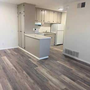 Albuquerque apartment for rent - A kitchen with a white fridge and a countertop.