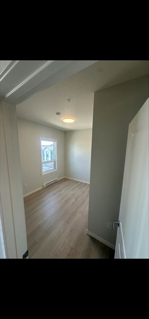 Calgary house for rent - A room with wooden flooring and a window.