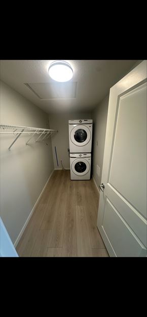 Calgary house for rent - A small laundry room with a washer and dryer.