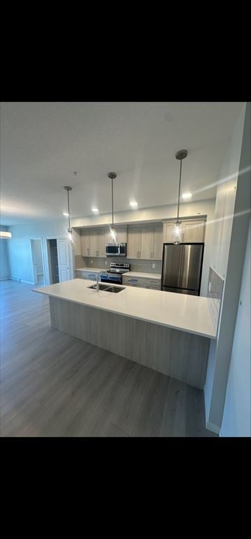 Calgary house for rent - A modern kitchen with a long counter and pendant lights.
