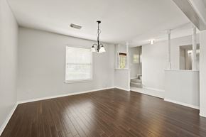 Houston house for rent - A room with wooden floors and white walls.