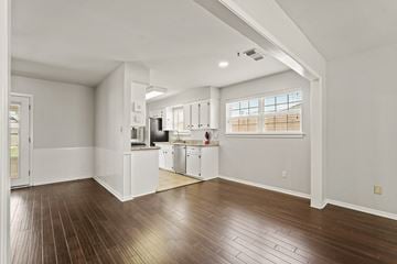 Houston house for rent - A spacious kitchen with white cabinets and a window.