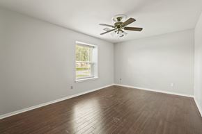 Houston house for rent - A room with a ceiling fan and a window.