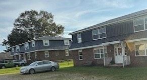 Springville apartment for rent - A car is parked in front of a two-story house.