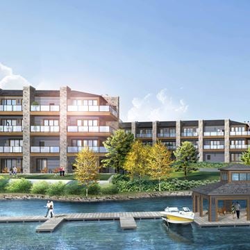 Huntsville apartment for rent - A modern building with a dock and a boat in front of it.