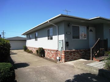Half Moon Bay apartment for rent - A house with a grey roof and a white garage door.