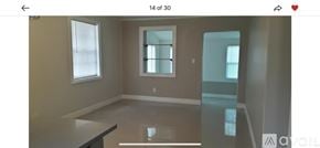 West Palm Beach house for rent - A room with a large window and a glass table.