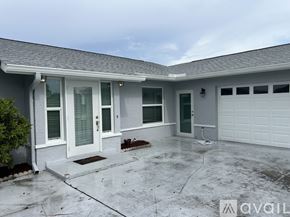 Cape Coral house for rent - A house with a grey roof and a white garage door.