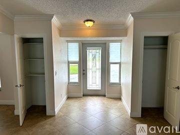 Cape Coral house for rent - A kitchen with white cabinets and granite countertops.