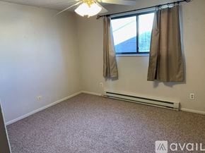 Loveland apartment for rent - A room with a window and a fan on the ceiling.