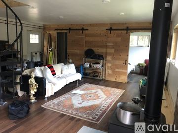 Middlesex house for rent - A living room with a white couch and a rug on the floor.