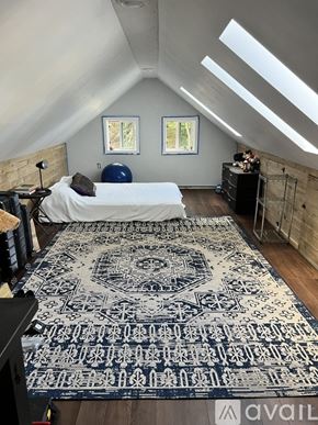 Middlesex house for rent - A bedroom with a bed, a dresser, and a rug with a pattern on it.