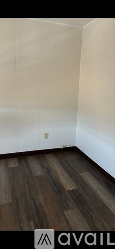 Scranton house for rent - A room with wooden flooring and white walls.